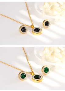 Detail of gold crystal necklace and stud earring sets with black and green gems