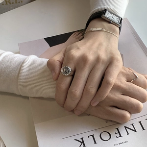 Detail of vintage 925 sterling silver eye ring and V-shaped band on model's hand