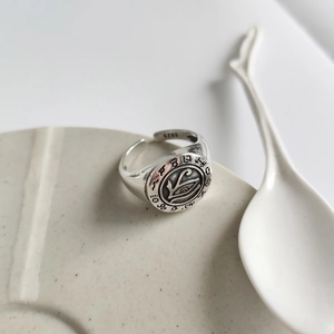 Detail of S925 sterling silver ring with Eye of Horus carving on ceramic plate