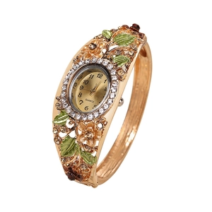 Vintage gold bangle watch with green floral enamel and quartz crystal inlay