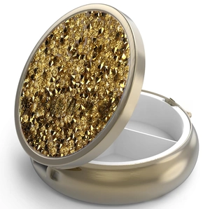 Detail of round golden metal pill box featuring luxury crystal inlay and internal divider