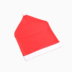 Red Christmas hat chair cover with white plush pompom and fuzzy trim on white background