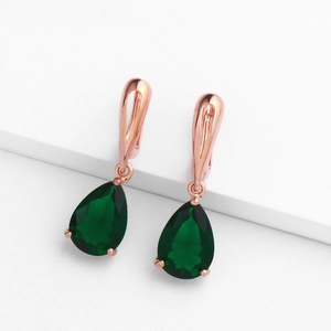 Eleganti orecchini in oro rosa con gocce di cristallo verde a forma di pera su display