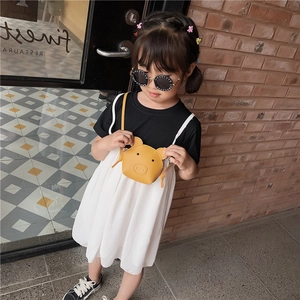 Cute yellow pig cartoon shoulder bag for kids made of PU leather shown on a young girl