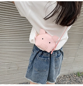 Detailed view of pink pig cartoon mini shoulder bag for kids in durable PU leather