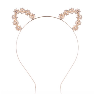 Detailed view of cat ear headband in gold metal with daisy floral decorations