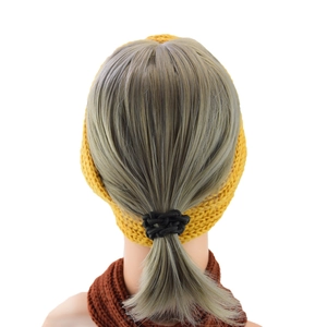 Rear view of thick knit yellow headband and black hair tie on a mannequin head