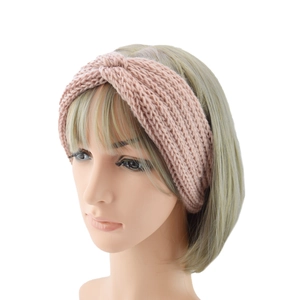 Detailed close-up of a pink twisted knit headband featuring thick vertical ribbing texture