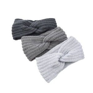 Detail showing hand-knit chunky cable textures on gray winter ear warmer headbands