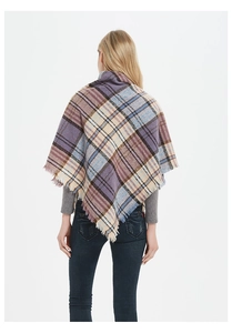 Detail shot of multicolor plaid knit scarf with purple and blue fringe texture