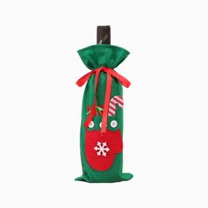 Christmas wine bottle cover made of green felt with red glove accents on white background