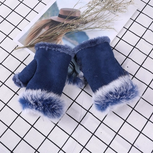 Detailed view of dark blue suede fingerless gloves with white faux fur trim on plaid cloth
