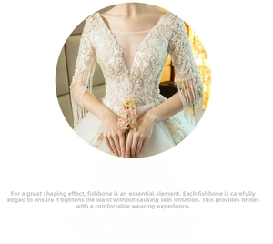 Close-up of ivory wedding dress with lace embroidery and beaded tassel shoulder details