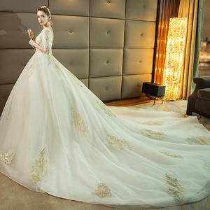 Elegant white ball gown wedding dress with long train and lace applique details