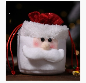 Close-up of plush Christmas Santa gift bag with soft white fur and red drawstring closure