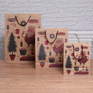 Three sizes of Christmas kraft paper gift bags with festive Santa and tree illustrations