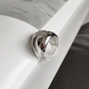 Detailed view of 925 sterling silver minimalist open ring on a clean geometric background