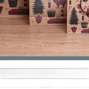 Detail of Christmas kraft paper gift bag showing festive prints on a wood background