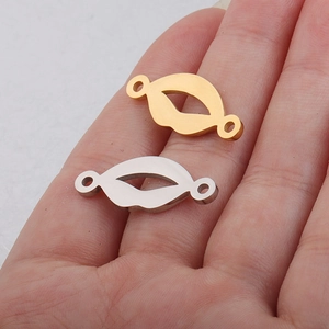 Detailed view of gold and silver lip pendants on palm to show 10x25mm size