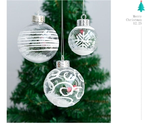 Detail of 6cm clear Christmas balls with pine needles, berries and white snowflake patterns