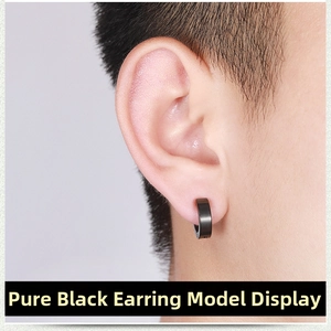 Close-up of black punk titanium steel clip-on earring worn on a male ear model