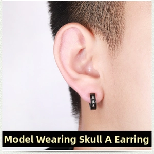 Macro detail of black punk ear clip featuring white skull and crossbones print design