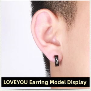 Close-up of black punk clip-on earring with laser-engraved I Love You lettering on model