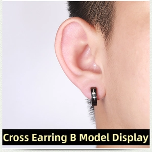 Close-up of black punk clip-on earring with a white cross pattern worn on the ear