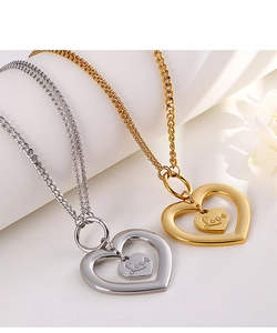 Detail view of interlocking heart necklaces in gold and silver with Love engraving
