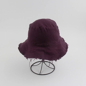 Detail shot of a dark purple cotton canvas sun hat with vintage frayed brim edges
