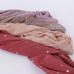 Close-up of premium chiffon hijabs with elegant hot-fix rhinestones and pearl embellishments