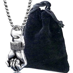 Polished silver fist pendant necklace for men with durable metal chain on black velvet