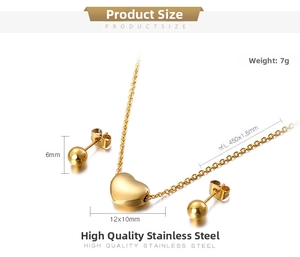 Detail view of gold heart necklace and ball studs set with stainless steel size labels