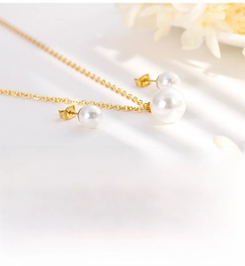 Vue macro d'une élégante parure de bijoux en perles dorées avec collier et boucles d'oreilles