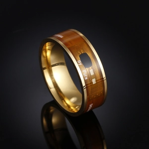 Macro shot of NFC smart ring featuring golden inner band and circuit pattern detail