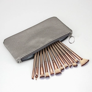 Set of 12 professional makeup brushes with brown handles and a silver zipper travel case