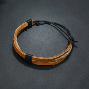 Detailed close-up of woven brown leather and beige hemp rope bracelet with adjustable knot
