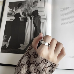Close-up of minimalist 925 sterling silver ring with irregular textured surface design