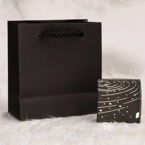 Minimalist black jewelry gift box and paper bag with silver starry sky pattern detail