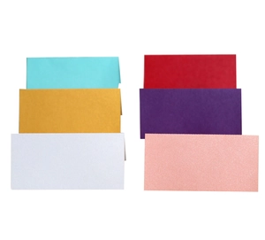 Macro detail of pearlescent paper place cards in six vibrant colors for wedding seating