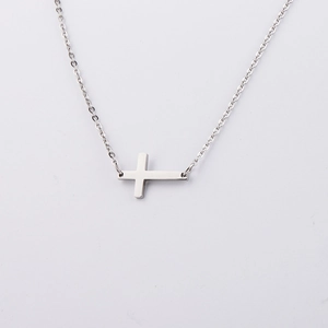 Close-up of a silver mirror-polished stainless steel horizontal cross pendant on a thin chain