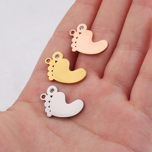 Polished stainless steel baby feet pendants in gold, rose gold, and silver with rhinestones