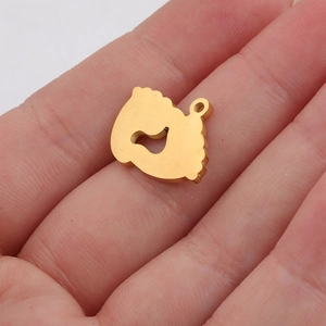 Polished gold stainless steel baby footprint pendant shown in palm for size scale
