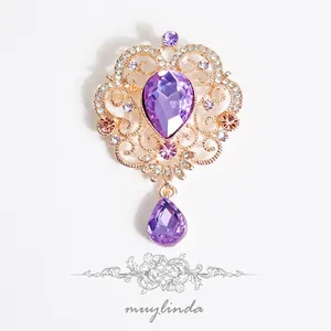 Baroque vintage gold brooch with purple teardrop crystal and hollow vine patterns