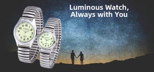 Close-up of silver elastic band quartz watches with luminous dials for couples
