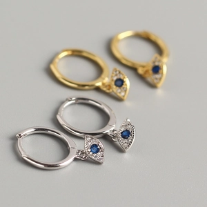 Detailed close-up of S925 sterling silver evil eye hoop earrings with blue stones