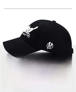 Close-up of the adjustable bronze metal buckle and neat inner stitching on a black baseball cap