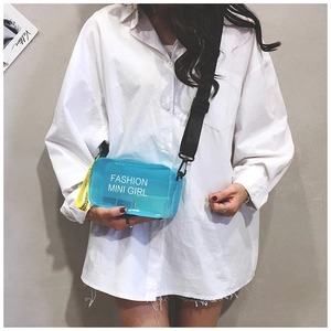 Detail of transparent blue jelly crossbody bag with Fashion Mini Girl text on model