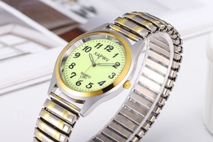 Macro shot of XAPWV luminous dial with black numerals and gold-silver elastic metal band