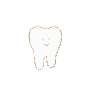 Detail of cartoon tooth enamel brooch with golden edges and a cute minimalist smile